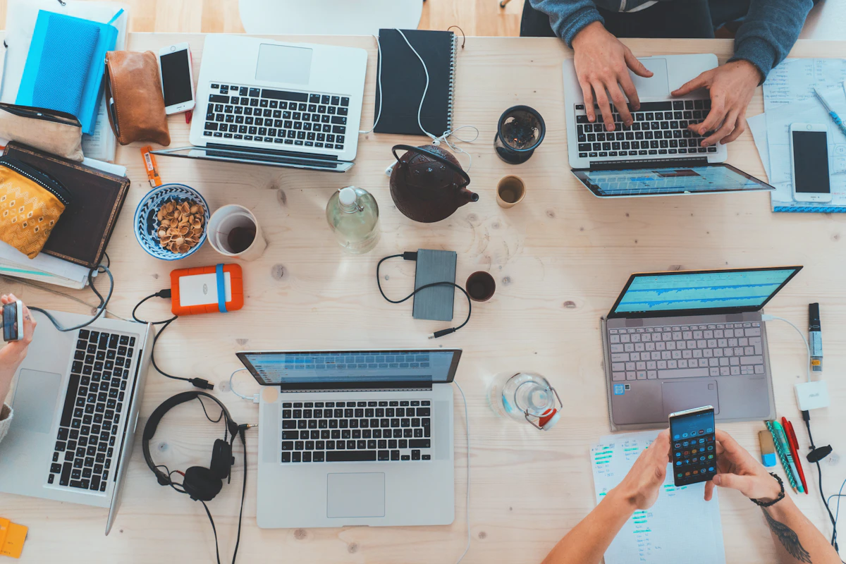 People collaborating around computers at a table